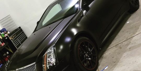 Cadillac wrapped in Avery SW Satin Black vinyl