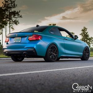 BMW wrapped in 1080 Satin Flip Caribbean Shimmer Cyan/Green shade shifting vinyl
