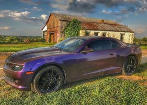 Chevrolet Camaro wrapped in Avery ColorFlow Gloss Roaring Thunder Blue/Red shade shifting vinyl