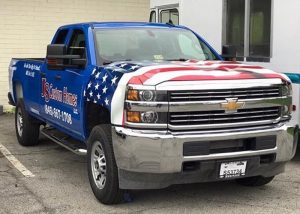 Chevrolet Silverado wrapped in Orafol 970RA Gloss Sea Blue base vinyl with custom printed Avery 1105EZRS overlays