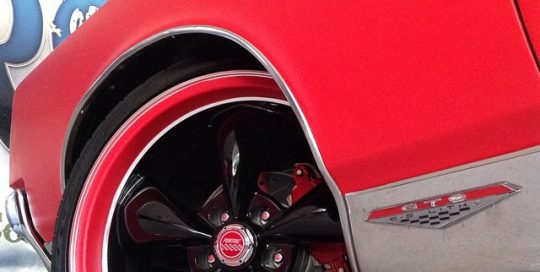 Pontiac wrapped in Matte Red vinyl and Red Geranium Carbon Fiber vinyl on the wheel lip
