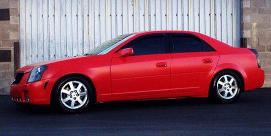 Cadillac wrapped in Avery SW900 Satin Carmine Red vinyl
