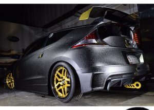 Honda wrapped in Orafol 975 Textured Black Honeycomb and Arlon Gold Chrome vinyls
