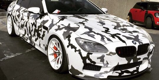 BMW wrapped in 1080 Gloss White base layer with matte and gloss camo vinyl overlays