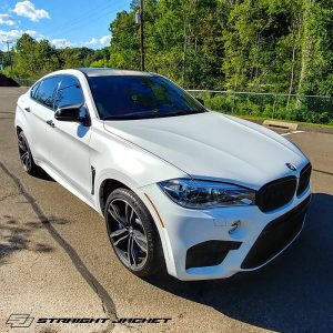 BMW X6M wrapped in Satin White vinyl