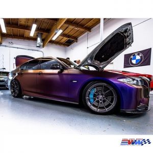 BMW 5 Series wrapped in Avery ColorFlow Satin Roaring Thunder Blue/Red shade shifting vinyl