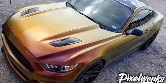 Ford Mustang wrapped in Avery ColorFlow Satin Rising Sun Red/Gold shade shifting vinyl