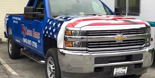 Chevrolet Silverado wrapped in Orafol 970RA Gloss Sea Blue base vinyl with custom printed Avery 1105EZRS overlays