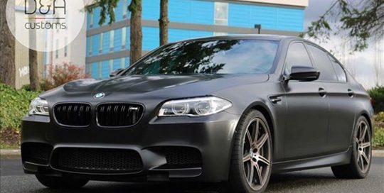 BMW M5 wrapped in Avery SW Satin Black vinyl
