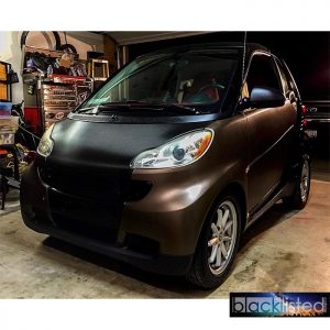 Smart Car wrapped in Matte Brown Metallic and Black Carbon Fiber vinyl