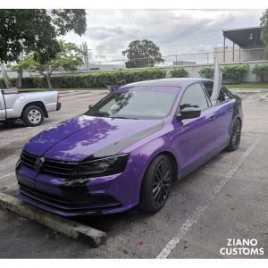 Volkswagen Jetta wrapped in Gloss Plum Explosion vinyl