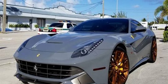 Ferrari F12 wrapped in Avery SW Gloss Dark Grey vinyl