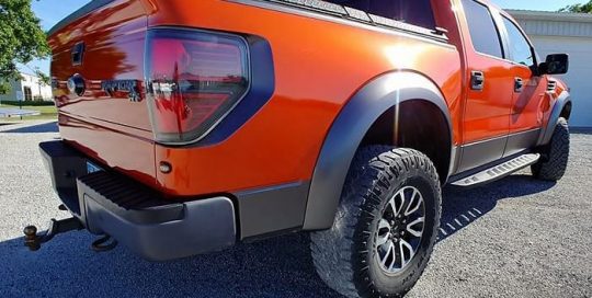 Ford Raptor wrapped in Gloss Fiery Orange vinyl