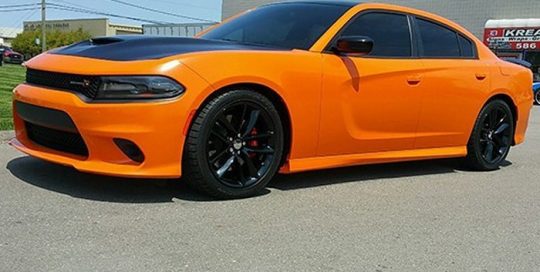Dodge Charger wrapped in Gloss Burnt Orange and Gloss Black vinyls