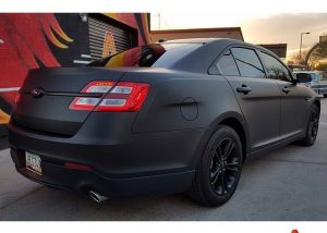 Ford Taurus wrapped in Matte Deep Black vinyl