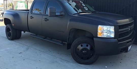 Chevy Silverado Dually wrapped in Matte Deep Black vinyl