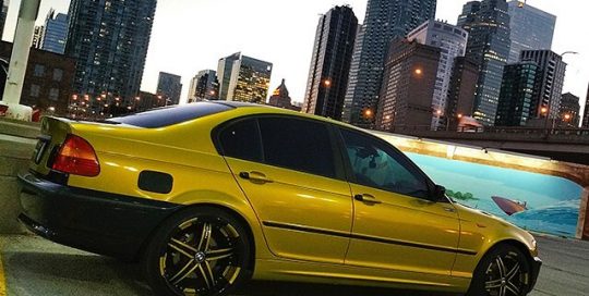 BMW 325i wrapped in Gloss Lemon Sting vinyl