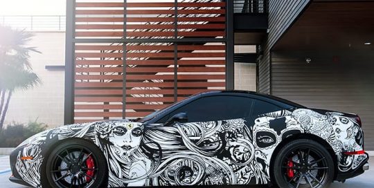Ferrari wrapped in custom printed 3M 1080 Matte Deep Black vinyl