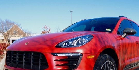 Porsche Macan wrapped in 3M 1080 Satin Smoldering Red vinyl
