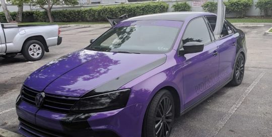 Volkswagen Jetta wrapped in 3M 1080 Gloss Plum Explosion vinyl