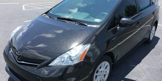 Toyota Prius wrapped in 3M 1080 Gloss Galaxy Black vinyl