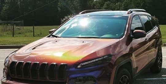 Jeep Cherokee wrapped in Avery ColorFlow Gloss Roaring Thunder Blue/Red shade shifting vinyl