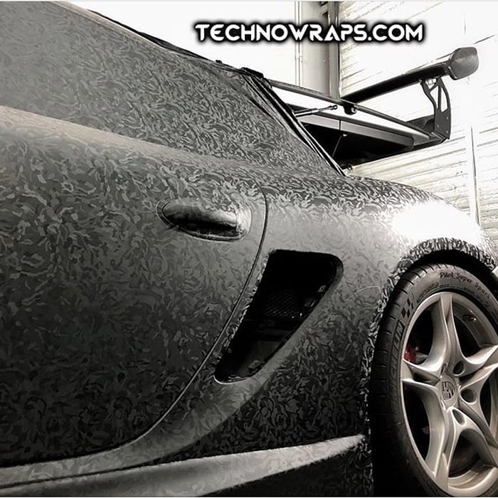 Porsche Cayman wrapped in 3M 1080 Shadow Black vinyl