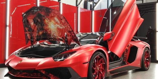 Lamborghini wrapped in Avery SW Red Chrome with 1370Z Luster overlaminate and custom printed 3M 1080 Satin Flip Ghost Pearl with 8518 Gloss overlaminate and accents in Orafol 970RA Black Honeycomb vinyl