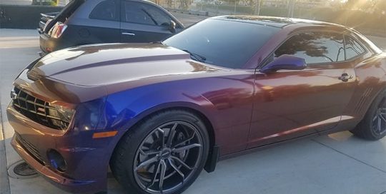 Chevrolet Camaro wrapped in Avery ColorFlow Gloss Roaring Thunder Blue/Red shade shifting vinyl