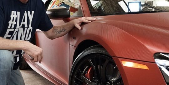 Audi R8 wrapped in Red Aluminum Carbon Fiber vinyl