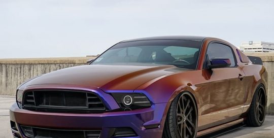 Ford Mustang wrapped in Avery ColorFlow Gloss Roaring Thunder Blue/Red shade shifting vinyl