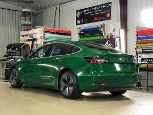 Tesla Model 3 wrapped in Avery Gloss Dark Green vinyl