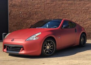 Nissan 370z wrapped in Satin Red Aluminum vinyl