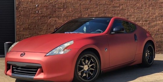 Nissan 370z wrapped in Satin Red Aluminum vinyl