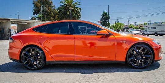 Tesla wrapped in 3M Gloss Fiery Orange vinyl
